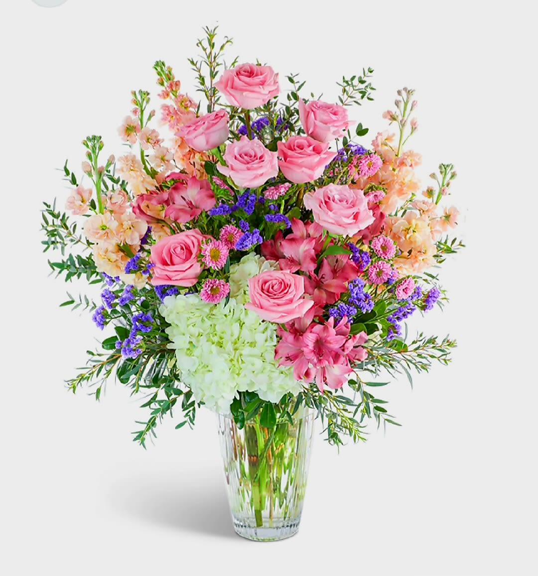 Meadow Springs by Pretty in Petals  - Looking for a get-well, anniversary, or housewarming present? Then you should consider Meadow Springs. It is an elegant flower arrangement featuring hydrangeas,  roses, and more. They come in beautiful white, pink, and green shades, and they are the perfect present for someone you care about.