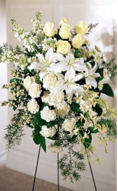 WHITE ELEGANCE SPRAY WHITE ELEGANCE SPRAY - A MIXTURE OF WHITE FLOWERS ON AN EASEL