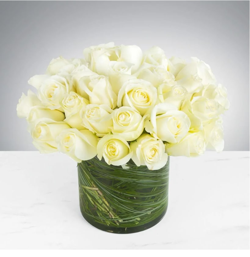 Perfect by Pretty in Petals Perfect by Pretty in Petals - Make a bold statement with this elegantly simple design. White roses symbolize hope, honor, adoration, and innocence. 36 White Roses is the perfect gift to welcome new beginnings or show your respects. . Arrangement Details: Three dozen white roses in a glass cylinder vase. APPROXIMATE DIMENSIONS are 11"D X 12"H