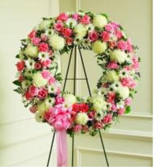 WREATH PINK & WHITE WREATH PINK & WHITE - A LOVELY MIXTURE OF PINK AND WHITE FLOWERS IN THE SHAPE OF A WREATH ON AN EASEL