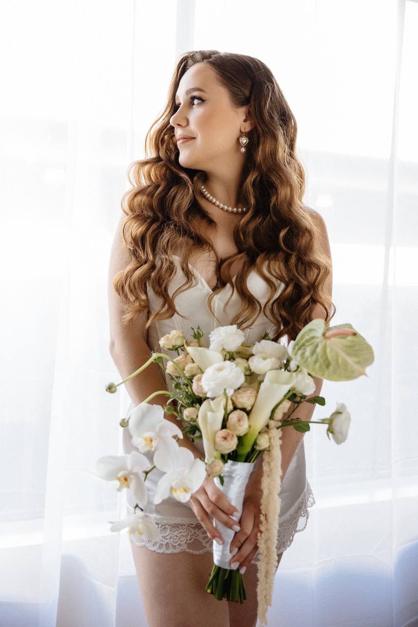 Forever &amp; Always - Forever &amp; Always  A romantic and elegant bridal bouquet featuring pristine white ranunculus, soft peach-cream spray roses, elegant calla lilies, lush green anthurium, creamy amaranthus, and delicate white orchids. This harmonious arrangement combines timeless sophistication with gentle, dreamy tones, perfect for a bride seeking a refined and graceful floral statement.