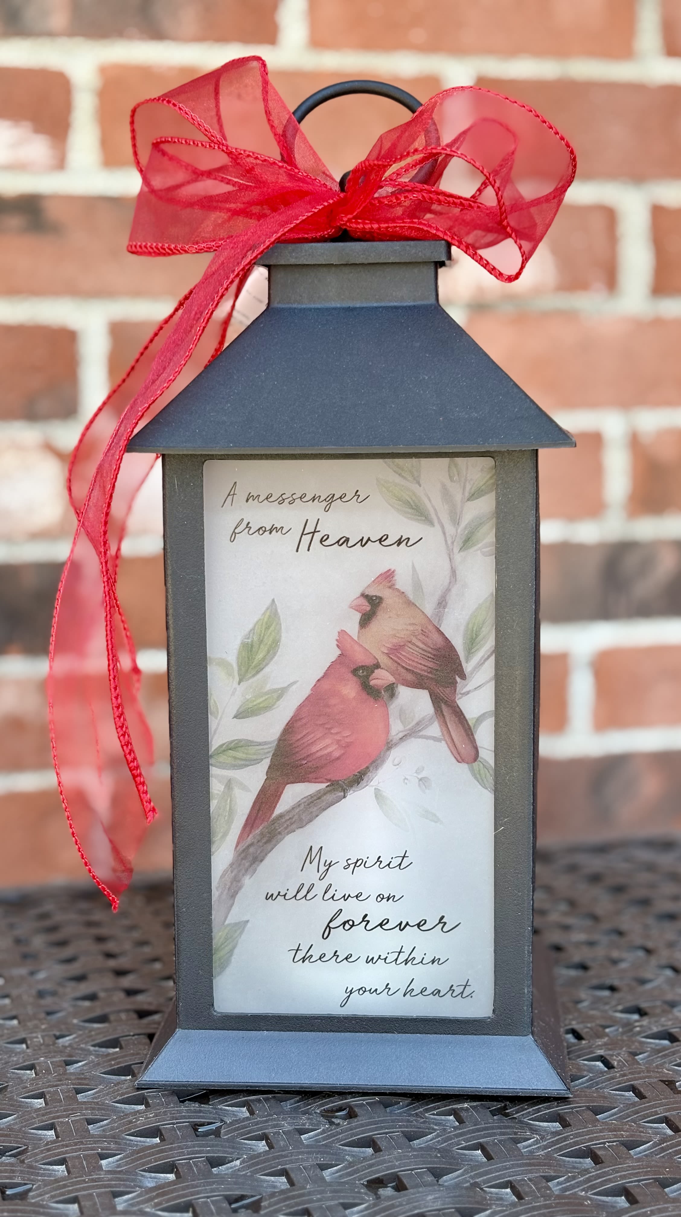 Thoughtful Cardinal Messenger Lantern  - This beautiful memorial lantern is a heartfelt way to honor and remember a loved one. Adorned with ribbon and featuring two cardinals - - symbols of love, hope and spiritual presence - - this lantern features a comforting message:  “A messenger from Heaven. My spirit will love on forever there within your heart.”  This sweet remembrance gift will be cherished for years to come.