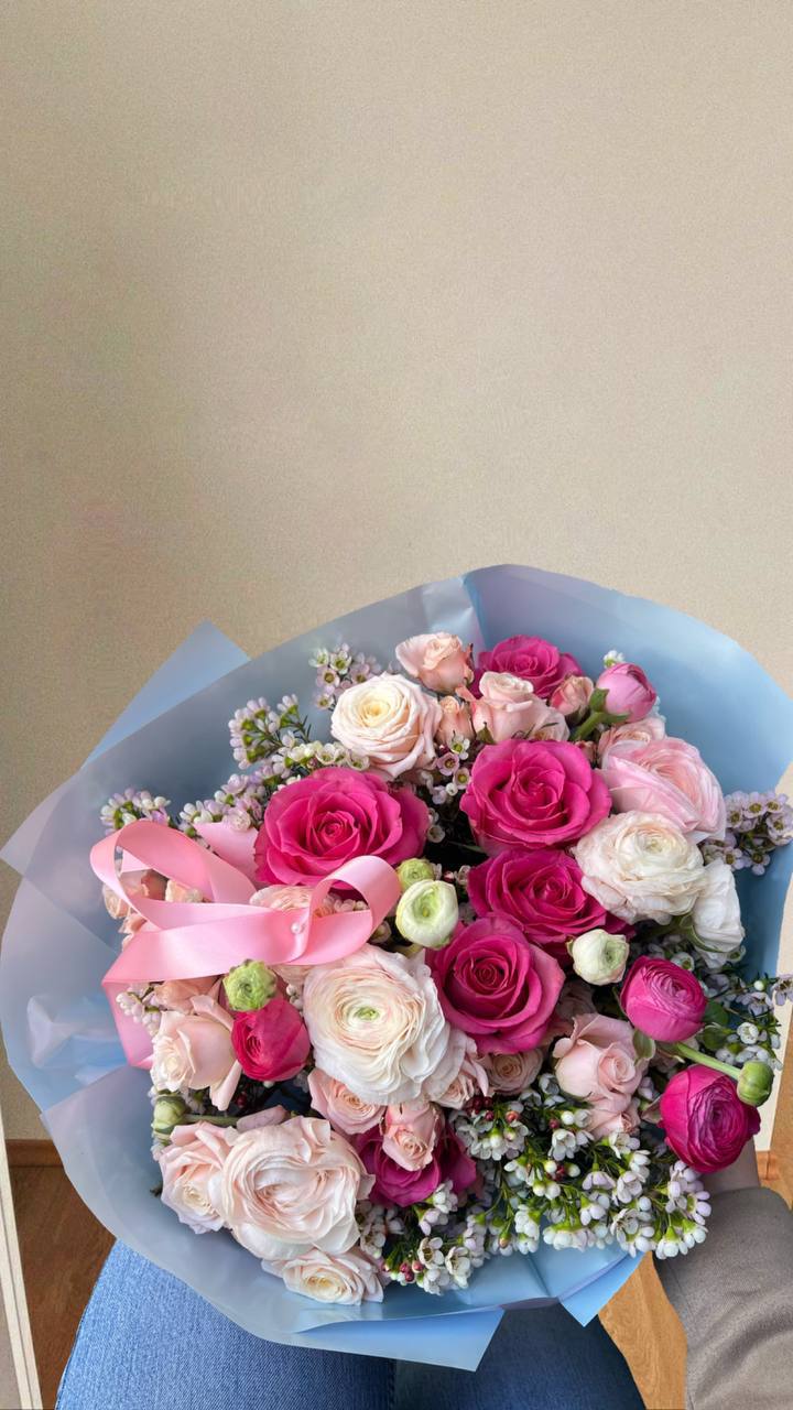Josephine  - Josephine  is a refined bouquet where graceful pink roses and delicate ranunculuses intertwine with subtle decorative greenery and tiny blooms. Smooth transitions from soft pastel shades to richer tones create an air of romance and femininity. This arrangement is perfect for conveying the warmest sentiments and adding a special charm to any day
