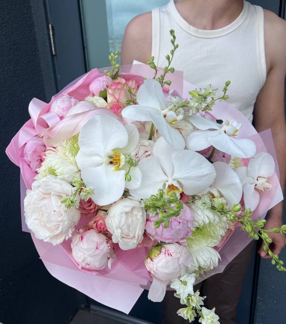 Peonies &amp; Orchid Paradise - Peonies &amp; Orchid Paradise A dreamy blend of delicate textures and soft elegance. This bouquet features lush peonies, snow-white chrysanthemums, cascading white orchids, and airy delphinium — creating a tender, luxurious moment frozen in bloom. Perfect for expressing grace, love, and timeless beauty.   