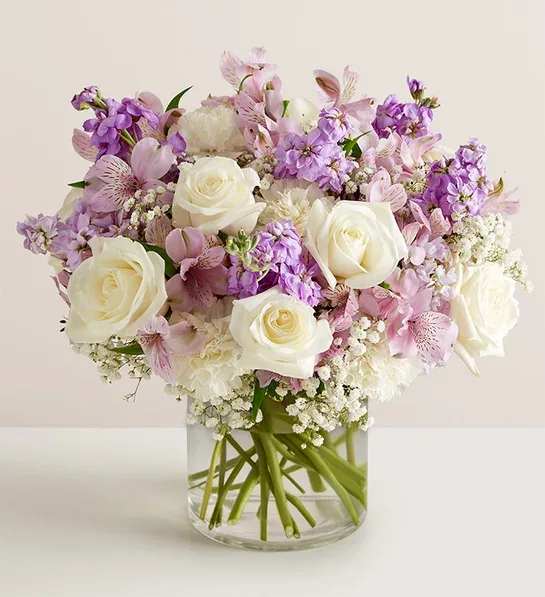 Lovely Lavender Medley - Lovely memories are made with thoughtful gifts for the ones we care about. Our charming lavender flower bouquet is loosely gathered with a medley of lavender &amp; white blooms. Hand-designed inside a clear cylinder vase with cascading greenery all around, it’s a wonderful way to express the sentiments you have inside your heart