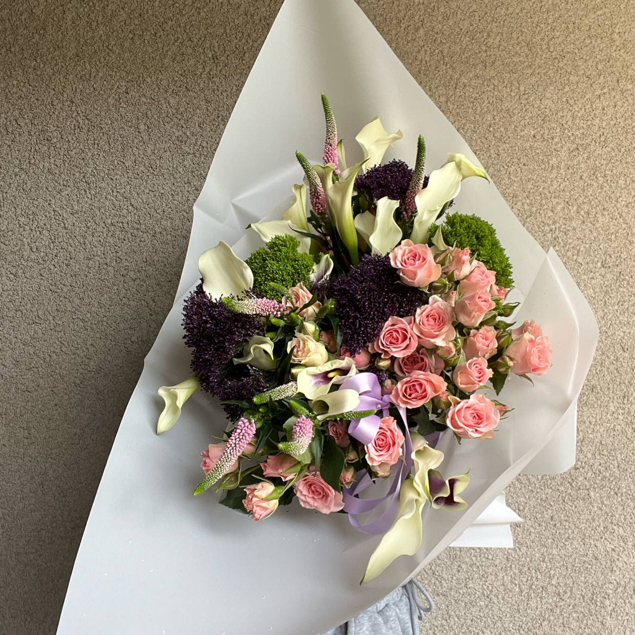 Adele - Bouquet “Adele” – a symbol of elegance and harmony. Pure white calla lilies represent grace and sophistication, soft pink spray roses add a touch of romance, while the elongated Veronica blooms and fluffy trachelium create depth and texture.  This bouquet is a perfect gift for a special occasion – a birthday, an anniversary, or simply as a heartfelt gesture.   