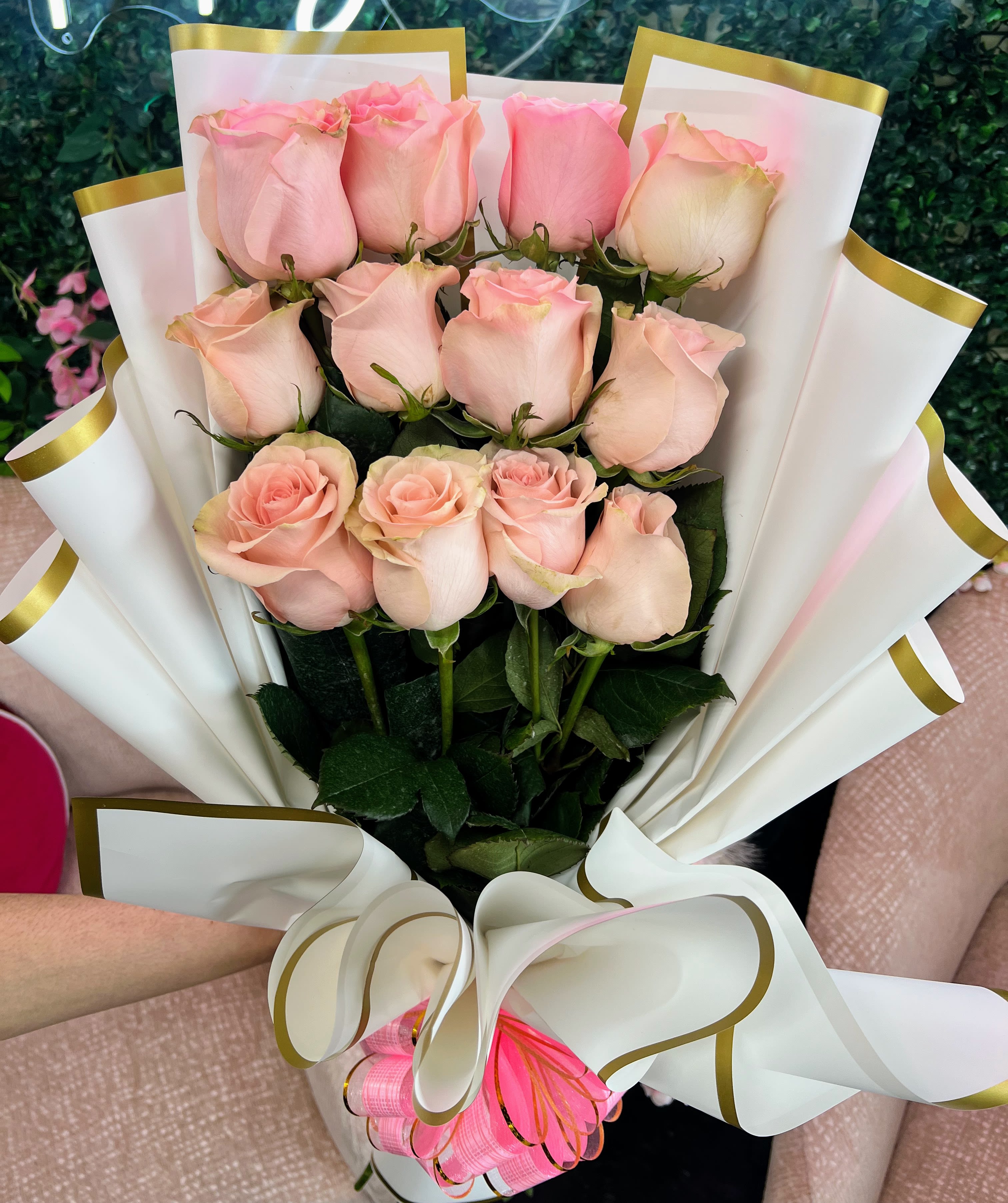 Wrapped Pink Rose Bouquet - Graceful, gentle, and effortlessly elegant — our Wrapped Light Pink Rose Bouquet captures the essence of sweetness and admiration. Each bloom is a soft blush of pastel pink, hand-selected for its delicate beauty and romantic charm. Perfectly wrapped and tied with satin ribbon, this bouquet is ideal for expressing love, celebrating milestones, or simply brightening someone’s day with a touch of tenderness. STANDARD 12 ROSES DELUXE 18 ROSES PREIUM 24 ROSES