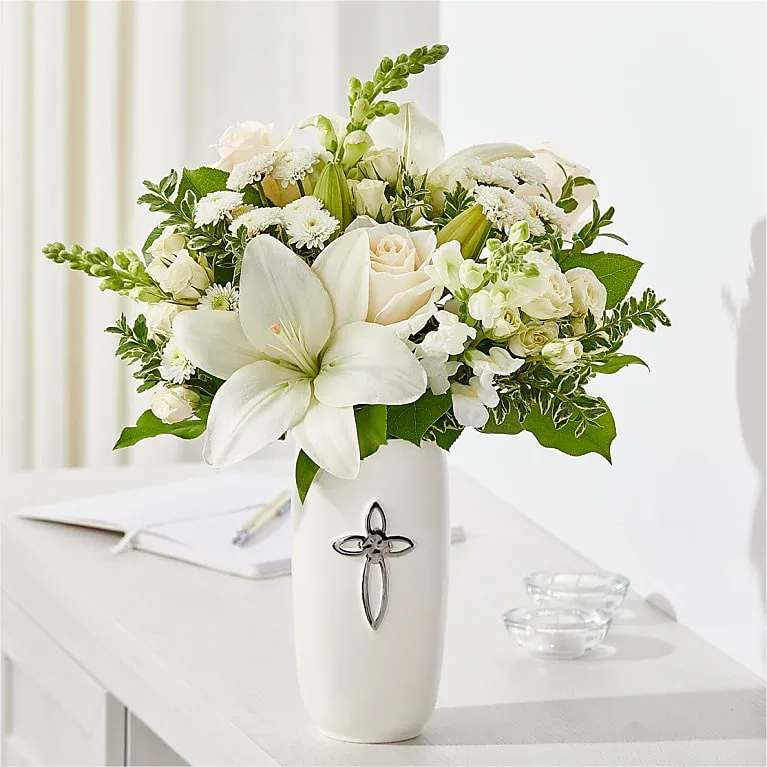 With Grace Bouquet - Our With Grace Bouquet is filled with timeless stems like roses and snapdragons, excellent for a religious event, holiday, wedding or to offer condolences. Presented in a creamy white ceramic vase with cross