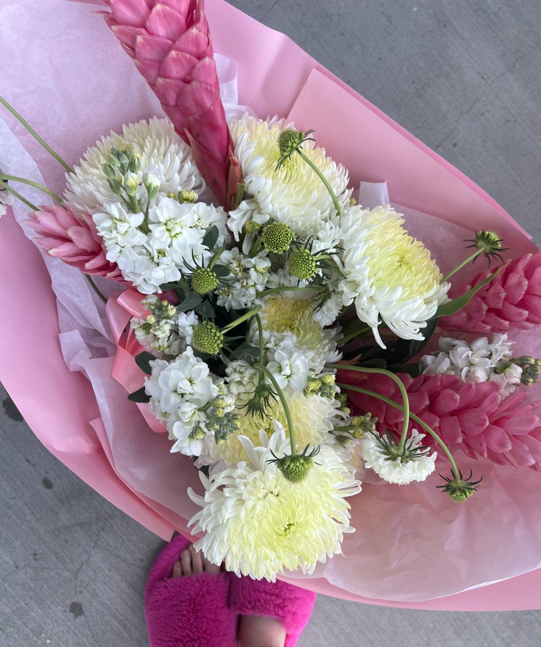 Tropical Tenderness - Bouquet “Tropical Tenderness” is the embodiment of refined exoticism and natural freshness. Delicate white chrysanthemums and airy clusters of matthiola harmoniously blend with the vibrant accents of pink alpinias and ginger flowers, creating a sense of lightness and romance. Wrapped in an elegant pastel-toned package, this bouquet symbolizes tenderness, warm feelings, and natural grace.  A perfect gift for a special occasion or simply to express love and care!