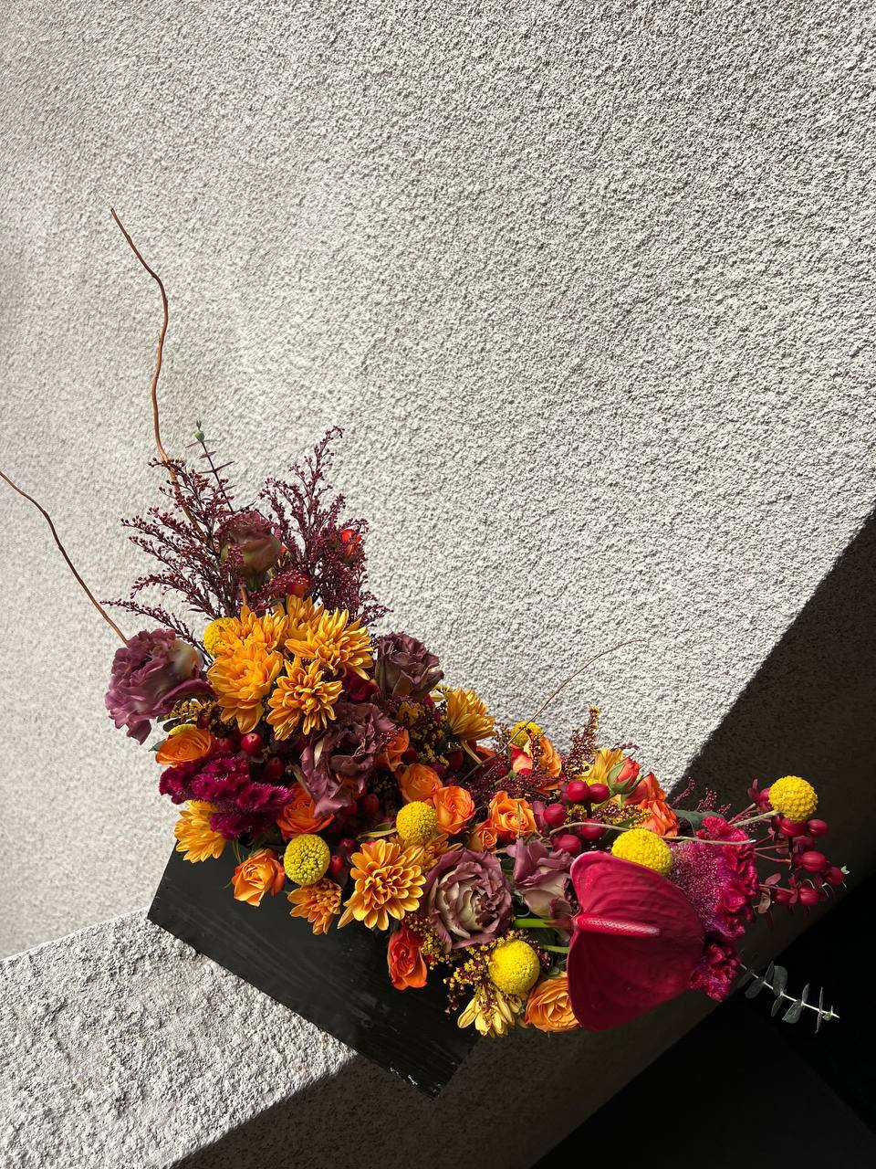 Blazing Symphony - “Blazing Symphony” is an expressive floral arrangement that embodies the fire of passion and the energy of autumn. Deep burgundy and rich orange hues intertwine with golden accents, creating the effect of a living flame. Velvety roses, exotic anthurium, delicate chrysanthemums, and bursts of berry tones add dynamism and expressiveness to the bouquet.  This arrangement is perfect for bold, charismatic personalities and special occasions when you want to convey warmth, emotion, and intensity of feelings. “Blazing Symphony” is more than just flowers—it’s a true spectacle, brought to life through natural colors and textures.