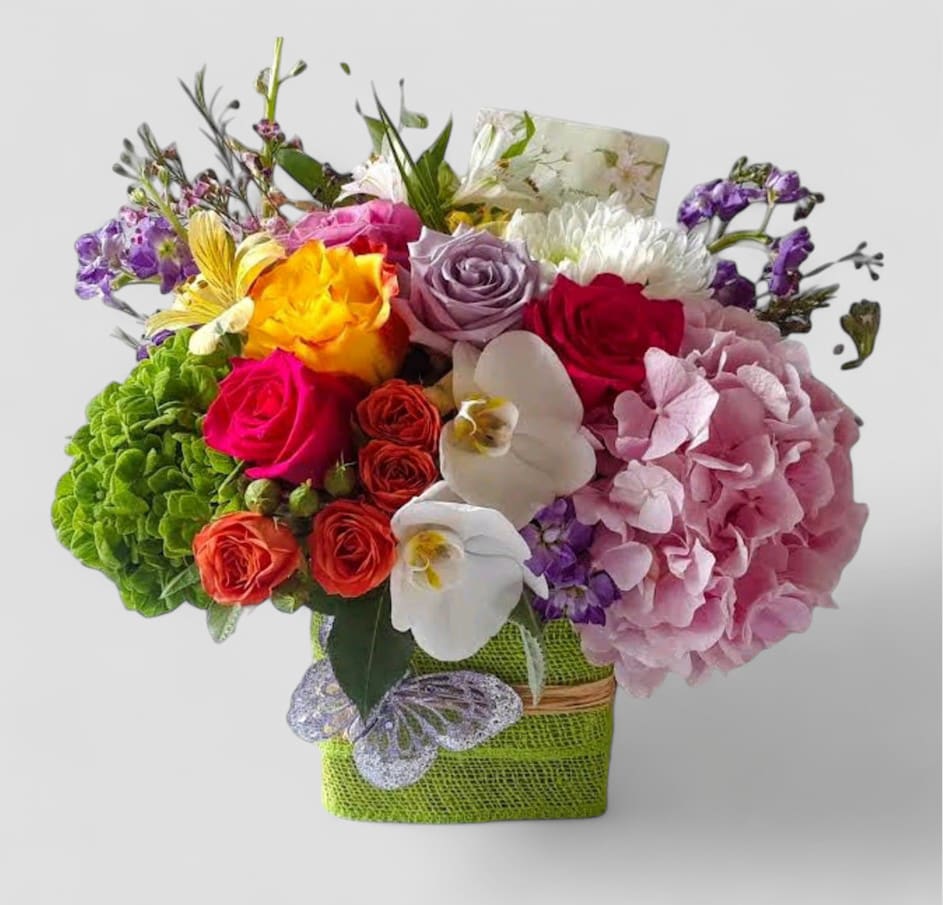 Colorful Blossoms Beauty Bouquet - Send this designer's choice colorful blossoms beauty bouquet today to show them how much you care with it's beautiful mixed orchids and roses arranged in a modern glass cube vase wrapped in pretty soft citrus jute ribbon. Always made unique different and extra special each and every time. Please visit my beautiful gallery to see my latest designs that I have created for my online customers. Send them happiness today.