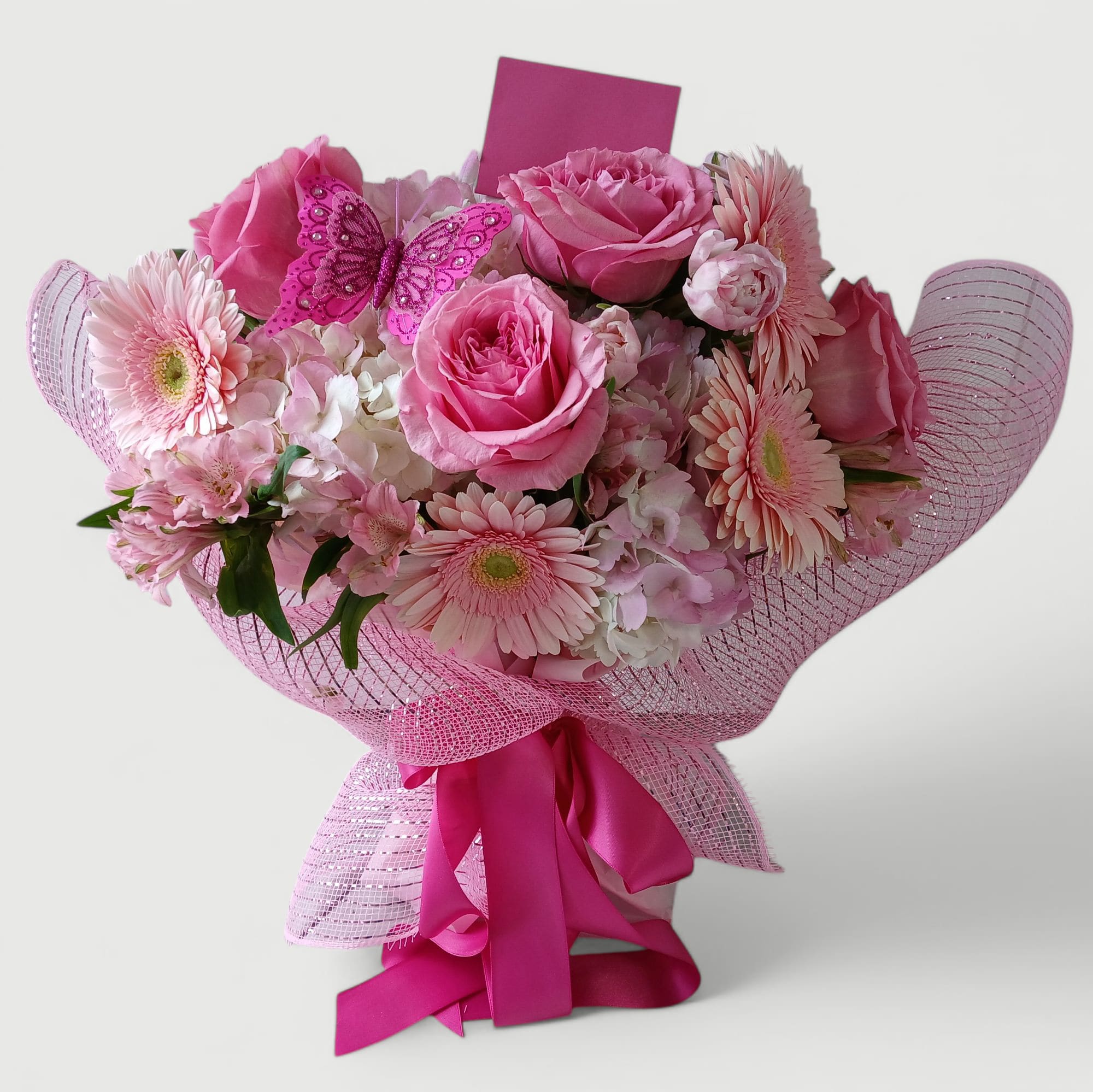 Pink My Favorite Rose Bouquet - Send this beautiful all pink bouquet today to make her day with roses hydrangeas daisies and so much more wrapped in pretty pink paper and mesh adorned with a lovely cheerful pink butterfly and long pink ribbon bow. Send her happiness today.