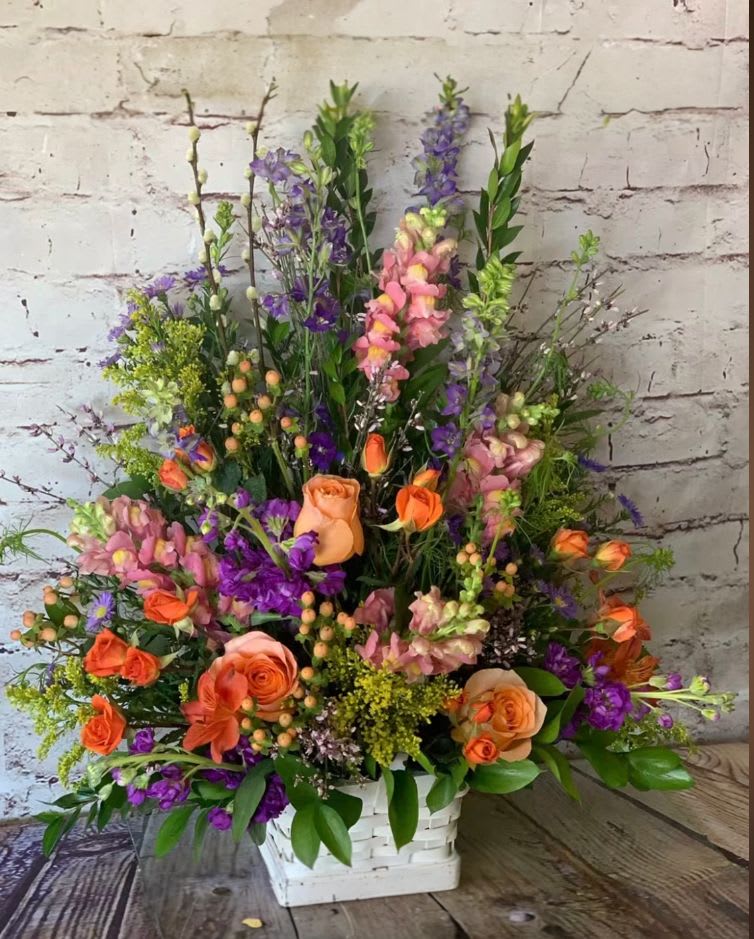 &quot;LINDSAY&quot; - This wooden rustic basket is overflowing with spring blossoms.  Roses, larkspur, snapdragons, hypericum berries, just to name a few.  A beautiful presentation! 
