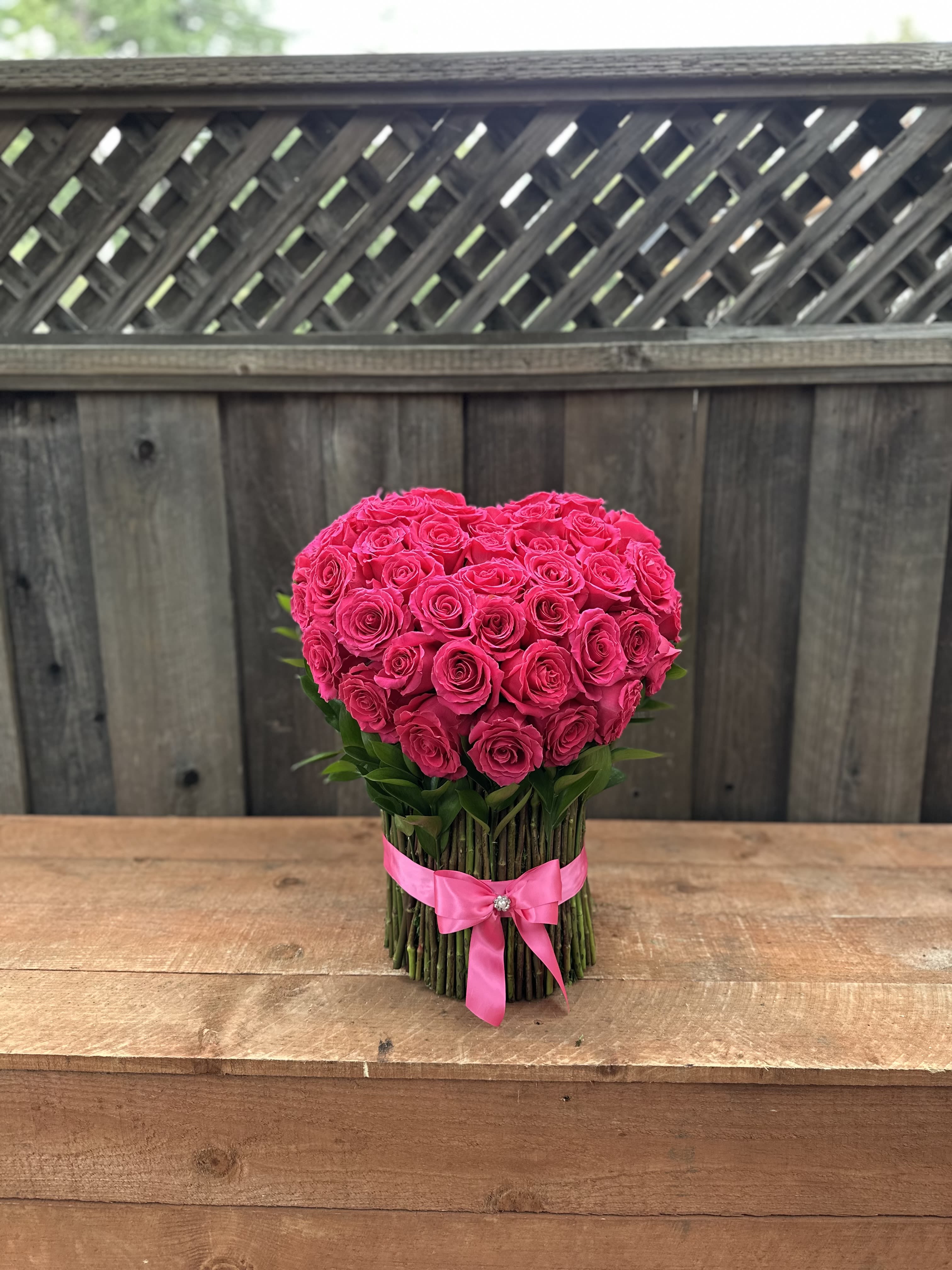 50 Standing Roses Heart Shaped by Arrangement By Pretty Petals Arrangements  - **50 Standing Rose Arrangement **    Looking to add a touch of *wow* to your event or space? Say hello to our **50 Standing Rose Arrangement** from *Pretty Petals Arrangements*!  This jaw-dropping masterpiece features **50 luxurious roses** standing tall, ready to steal the spotlight.  Whether it’s a wedding, anniversary, corporate event, or just because, this arrangement is the ultimate showstopper!     Each rose is handpicked for its freshness and beauty, so you know it’s going to look fabulous for days!     At *Pretty Petals Arrangements*, we’re all about creating floral magic that makes your heart skip a beat.  This arrangement isn’t just flowers—it’s a vibe, a mood, a whole experience!     Ready to turn heads and spark smiles?  Order your **50 Standing Rose Arrangement** today and let the petals do the talking!     *Pretty Petals Arrangements—where every bloom tells a story.* 