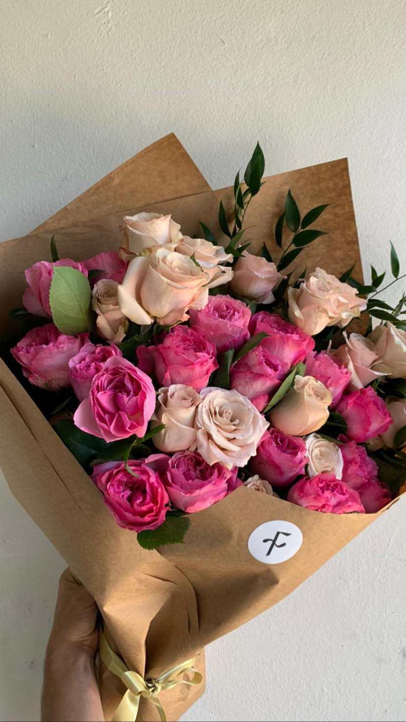 Rosas en Ramo - A beautiful bouquet of 1 dozen + 2 BONUS Long Stem roses  (14 total) with Israeli Ruscus at $50, two dozen at $75.99 and three dozens at $119.99 will impress any rose lover.  SPECIFIC COLOR UPON AVAILABILITY Premium Bouquet  shown//   