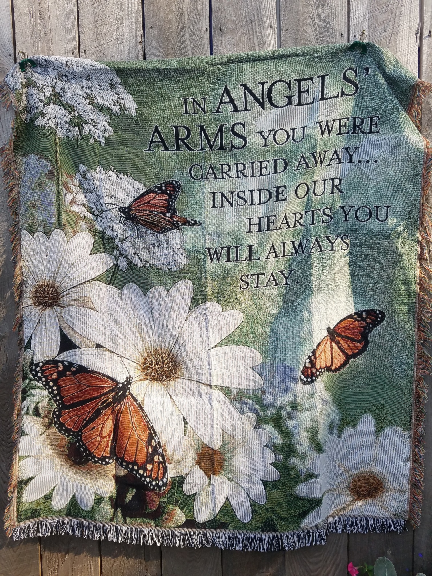 In Angels Arms - Butterfly Throw In Angels Arms - Butterfly Throw - This beautiful sympathy throw features colorful monarch butterflies and white daisies. The quote reads "In Angels Arms you were carried away, inside our hearts, you will always stay"