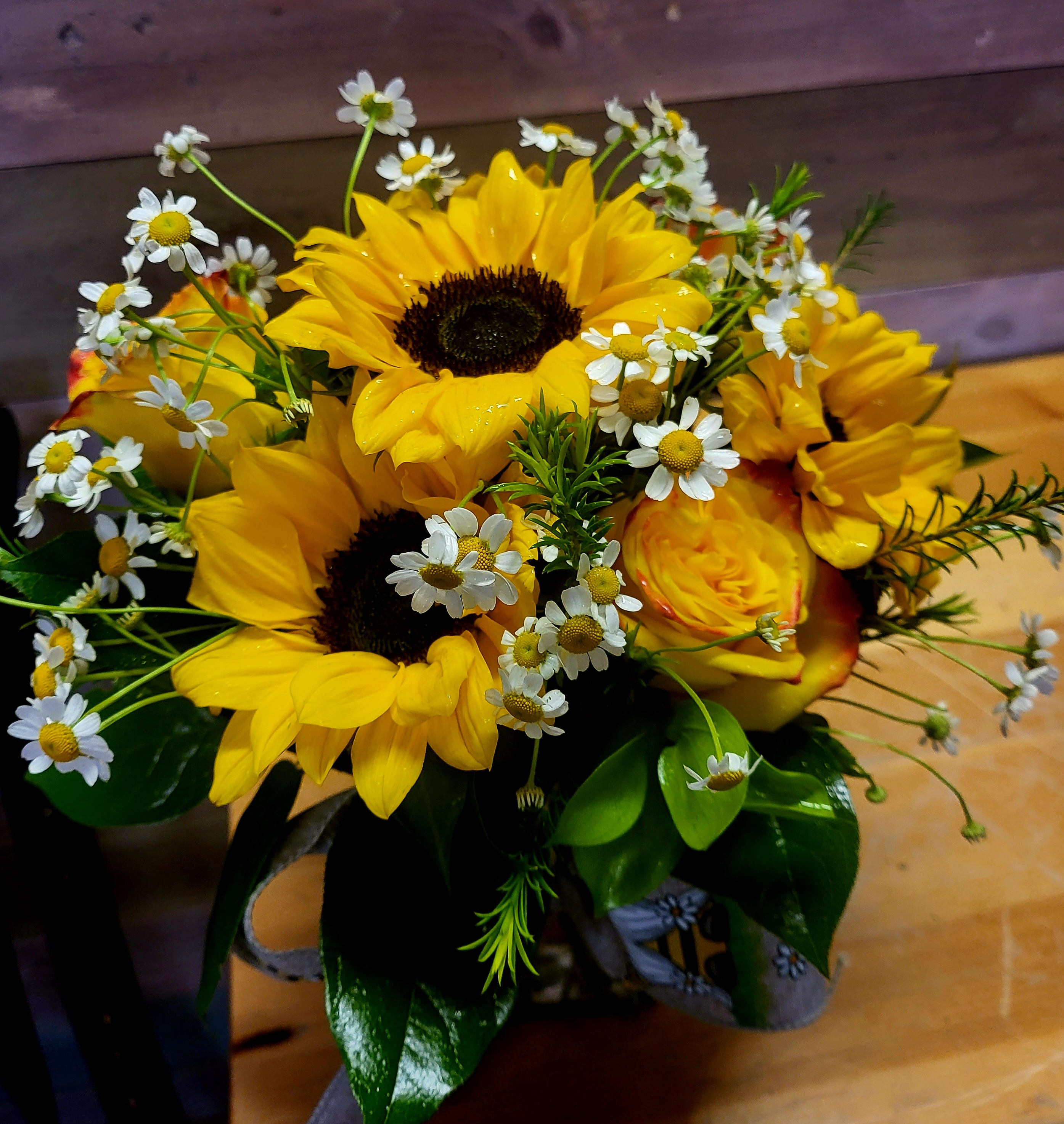 Dip into a little Sunshine - This is the perfect flower gift to brighten the day of the person that you are sending this too. A lovely mix of Sunflowers, Roses, Feverfew and what is currently in stock. 