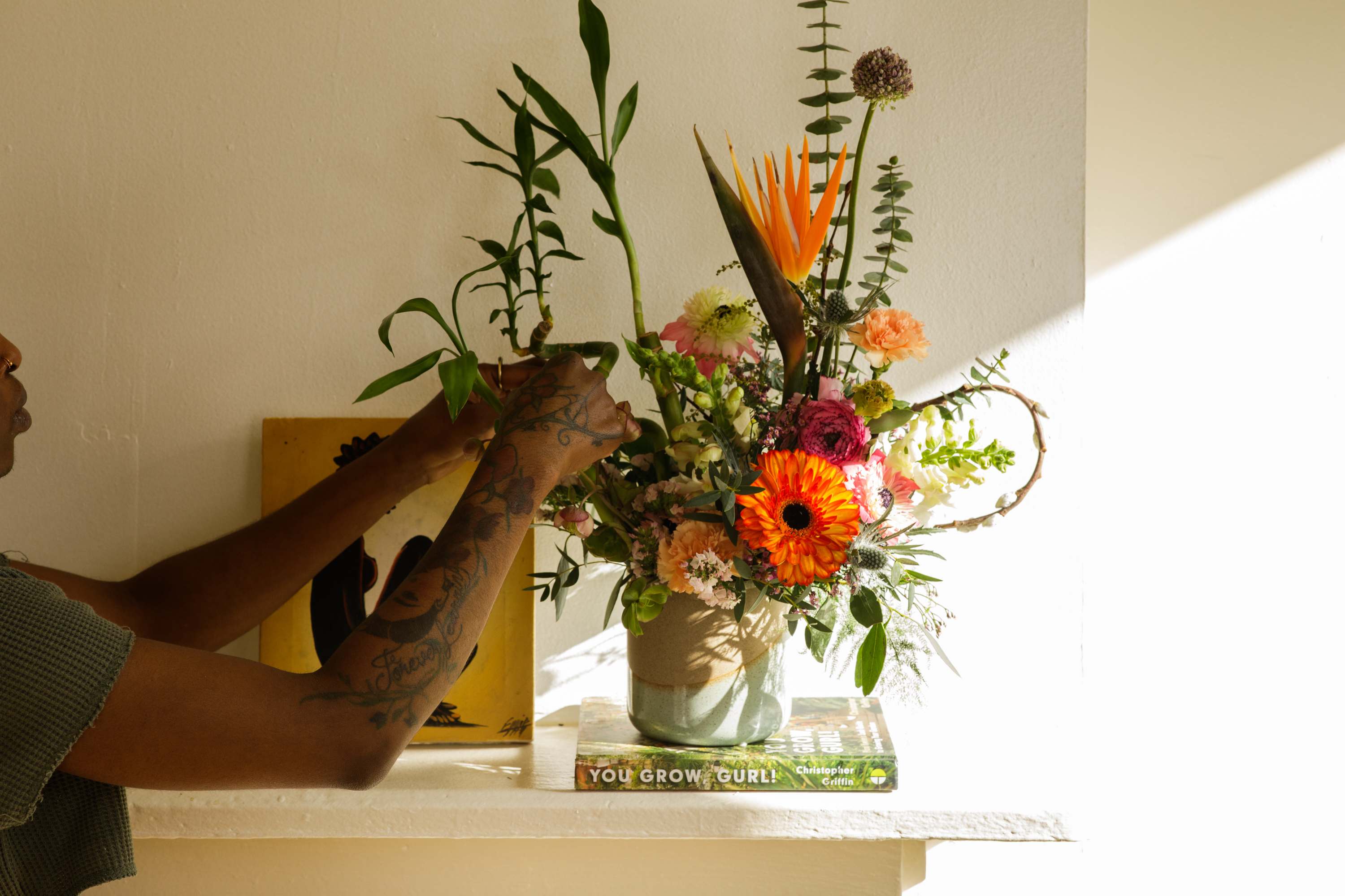 Bamboo &amp; Blooms Collection: The Blake  - &quot;The Blake&quot; is our short medium-sized modern arrangement created in a ceramic vase. By using &quot;Curly&quot; Lucky Bamboo and pairing with complimenting blooms this design is sure to be a sculpturally engaging arrangement for any space. Once the flowers have gone through it's life cycle enjoy the Lucky Bamboo in a beautiful vessel.   Each of our custom designs is created using fresh curated seasonal blooms. Designers will choose from a unique array of flowers and Lucky Bamboo to create an arrangement tailored for you. Just as no two people are alike so are our arrangments. For special floral requests please place order 4 days prior to the desired delivery date.     **Please note that Brooklyn Blooms move with the seasons, vessels, blooms, and foliage will vary from what you see in the photo. However, it will have the same beauty, uniqueness, and funky style. Please let us know in the florist notes if you have any color preferences, special requests, or love what's in the photo, otherwise, the Bloomies will make a tasteful decision for you! **  ***ALL SPECIAL REQUESTS MUST BE SPECIFIED IN THE FLORIST NOTES SO THAT OUR BLOOMIES ARE AWARE AND CAN DELIVER THE BEST SERVICE. COMMUNICATION IS KEY!!****  Upgrade Notes: Please note that with each upgrade the Bloomies will choose a mix of blooms, premium foliages, and filler to enhance your arrangement for the best presentation!  