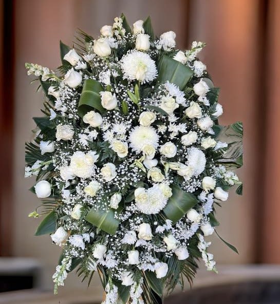 Classic White Standing Spray - This elegant funeral floral tribute features a graceful blend of white roses, chrysanthemums, lilies, and baby's breath, arranged with lush greenery. Designed as a white funeral standing spray, it symbolizes peace, remembrance, and heartfelt condolences.  Perfect for memorial services, celebrations of life, or funeral ceremonies, this sympathy flower arrangement is handcrafted to express deep respect and love. Available for same-day flower delivery in Los Angeles, this standing spray is a timeless and dignified gesture of support.
