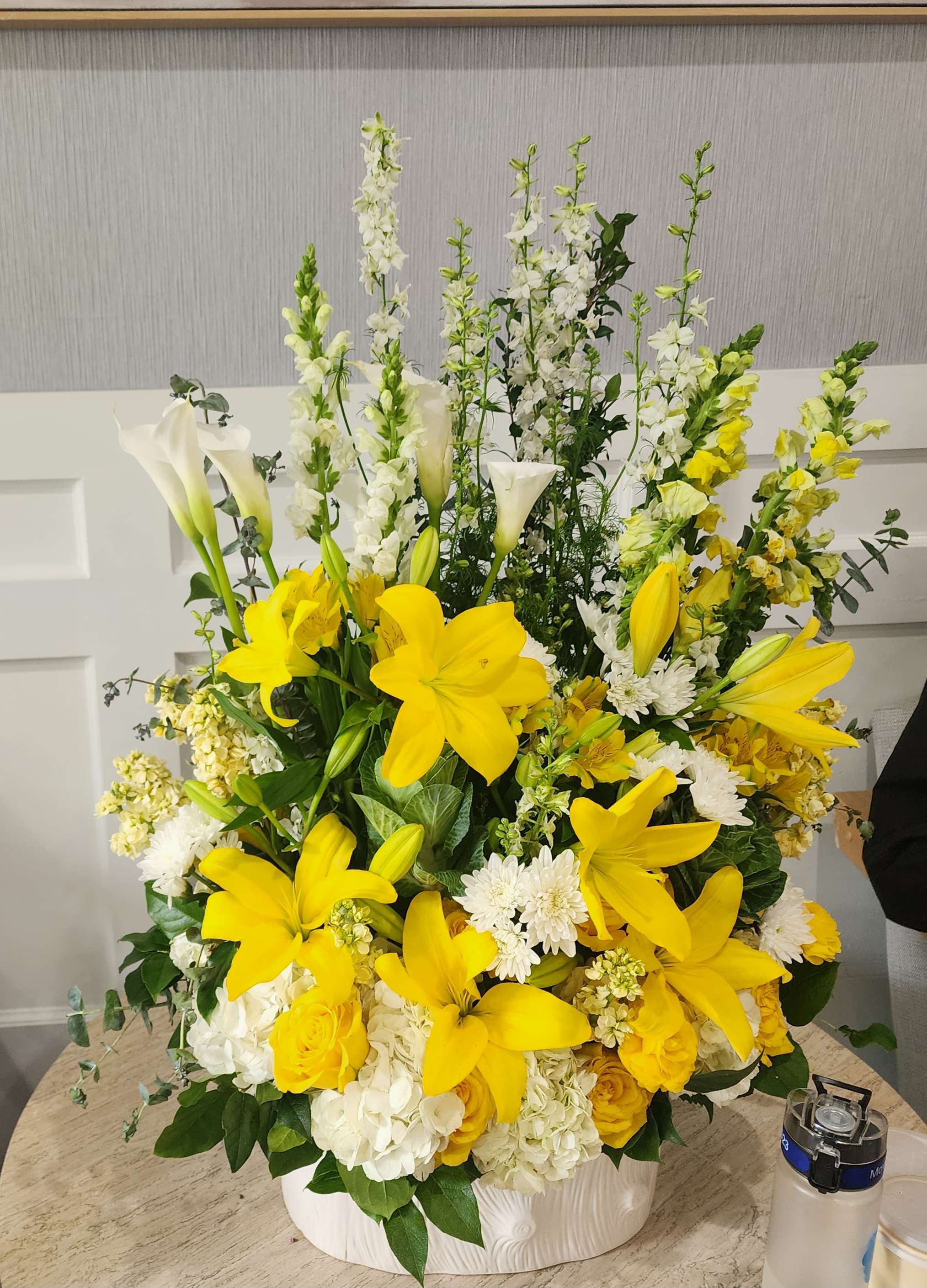 Golden Remembrance - This thoughtful arrangement features radiant yellow lilies paired with elegant white flowers, offering a heartfelt tribute. Designed to convey sympathy and hope, it brings a sense of peace and comfort during difficult times. Perfect for honoring a loved one, this bouquet symbolizes the bright memories and lasting legacy they leave behind.