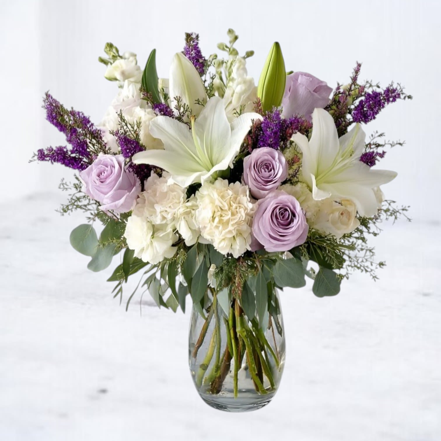 Sweet Dreams Bouquet Sweet Dreams Bouquet - Express grace and elegance with this stunning floral arrangement featuring soft pink roses, pure white lilies, delicate lisianthus, and fragrant stock. Thoughtfully arranged in a classic glass vase, this bouquet exudes timeless beauty, making it perfect for expressing sympathy, celebrating anniversaries, or simply bringing a touch of serenity to any space. The gentle blend of pastel hues creates a soothing presence, ideal for adding warmth and comfort to your home or as a thoughtful gift. Order this luxury bouquet for same-day delivery and let its delicate blooms convey your sentiments with grace.