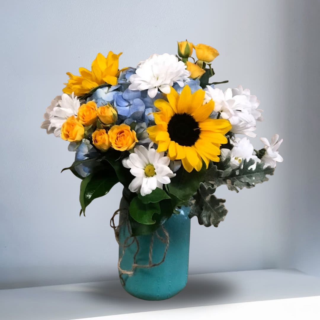 Little Bundle of Joy - Type of Flowers: Sunflowers, Blue Hydrangeas, White Daisies, Yellow Spray Roses, and Greens in a short, blue mason jar with rope ribbon. Availability: All year round Design View: All Facing View Photo shown: Regular 