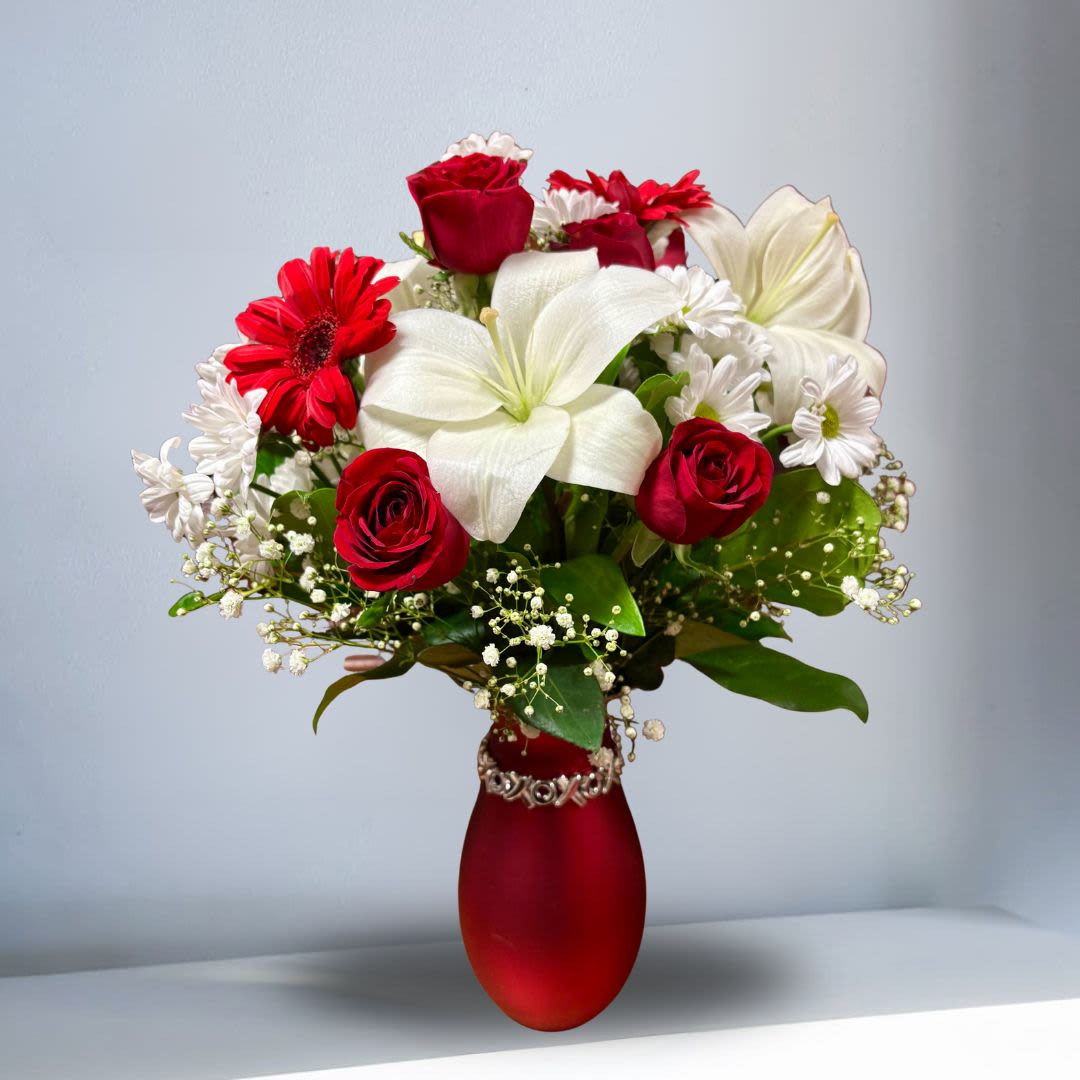 She's the One  - Your one and only love deserves an equally singular bouquet. Your loved one is sure to love this arrangement with this romantic mix of blooms presented in a beautiful red vase with an xoxo bracelet. 