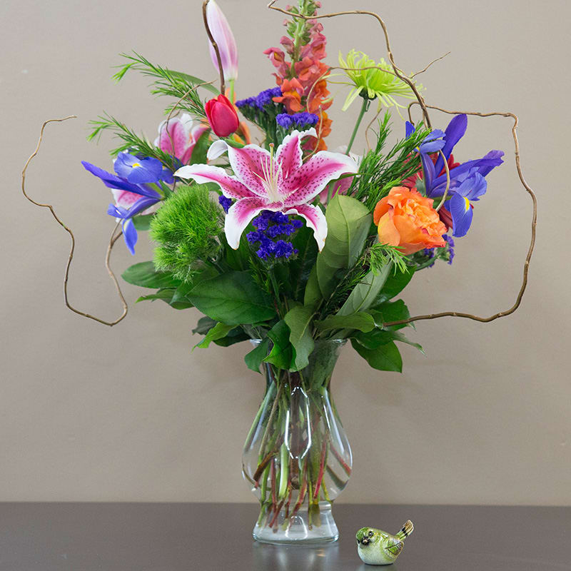Stargazer Pizzaz  - Stargazer Pizzazz is a vibrant celebration of color and texture, featuring the show-stopping stargazer lily at its heart. Accented with a lively mix of blooms such as iris, snapdragons, gerberas, alstroemeria, and curly willow, this bouquet is perfect for making a bold and joyful statement.
