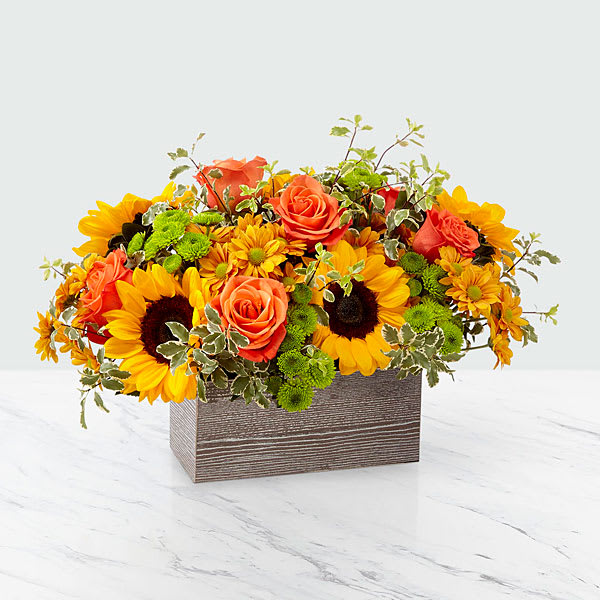 The FTD Garden Gathered Bouquet - Gathered straight from the garden sometimes it's beautiful to get to the point. A generous assortment of vibrant orange roses and sunflowers does just that in a weathered wooden rectangular box. Tell them how you feel with love that’s freshly picked. 