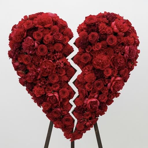 Everlasting LOVE By Black Cat Florist Everlasting LOVE By Black Cat Florist - The 'Everlasting LOVE' heart-shaped wreath is a profound and beautiful expression of a love that endures beyond a lifetime. This stunning tribute is a dense, elegant arrangement of rich red flowers, including classic red roses, symbolizing deep devotion and enduring love. The heart shape represents the eternal bond shared, making this wreath a personal and powerful statement of affection and remembrance. It provides a striking focal point and a loving message at any funeral or memorial service.