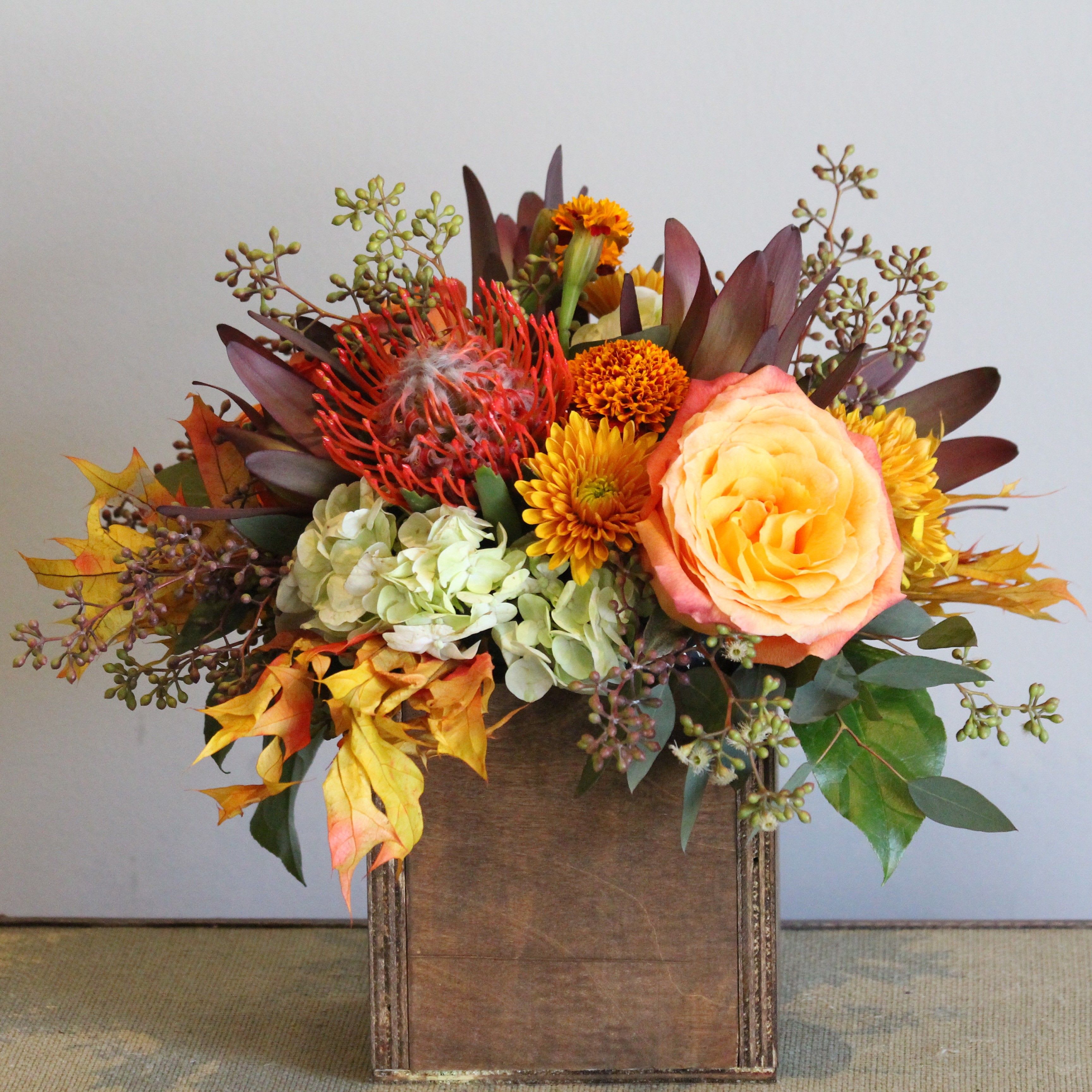Falling Leaves - Fresh fall Leaves, orange free spirit roses, red safari sunset, orange protea, white hydrangea and seeded eucalyptus berries in a vintage wood washed box