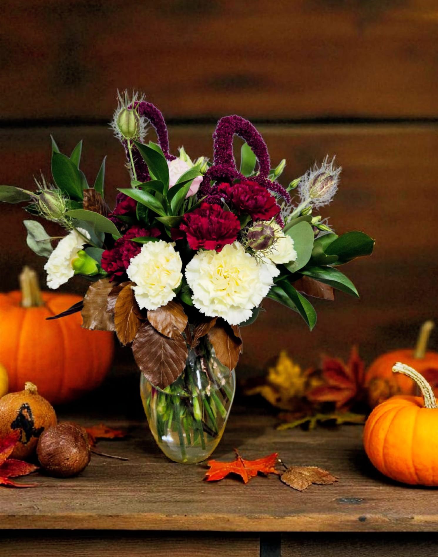 Rich Fall Rich Fall - This arrangement of deep burgundy, brown, green, and cream-colored flowers is a fall must. Bring in the harvest season with rich intention. Locally sourced burgundy Amaranthus and purple pods make this arrangement a fit for all.