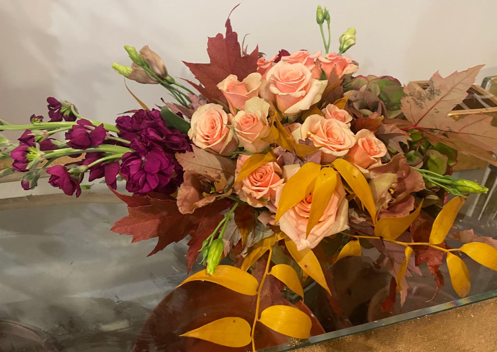 Autumn Serenade Autumn Serenade - A warm and romantic arrangement that captures the essence of fall with blush pink roses, rich burgundy stock, and golden foliage. Accented with vibrant maple leaves and soft lisianthus buds, this bouquet evokes the nostalgic beauty of a crisp, colorful autumn afternoon — perfect for seasonal décor or heartfelt occasions