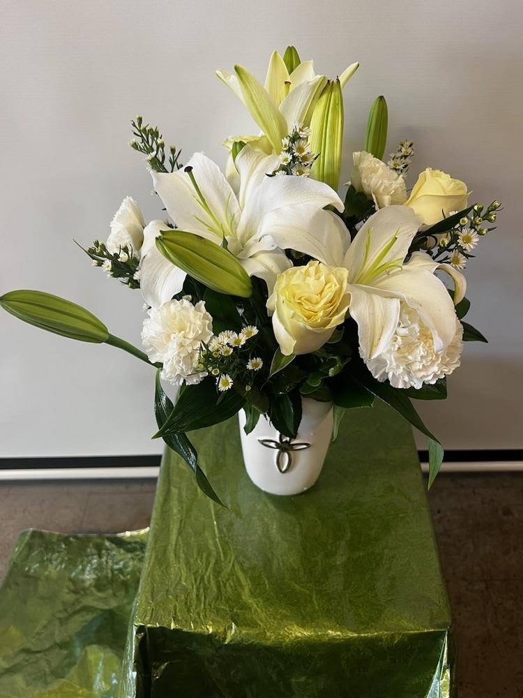 Peace of heaven bouquet Peace of heaven bouquet - An elegant display of faith and divine peace, this beautiful arrangement will comfort the bereaved in a truly thoughtful and respectful way. An exquisite vase cross is surrounded by a bed of lovely blossoms. It is sure to be appreciated and always remembered.