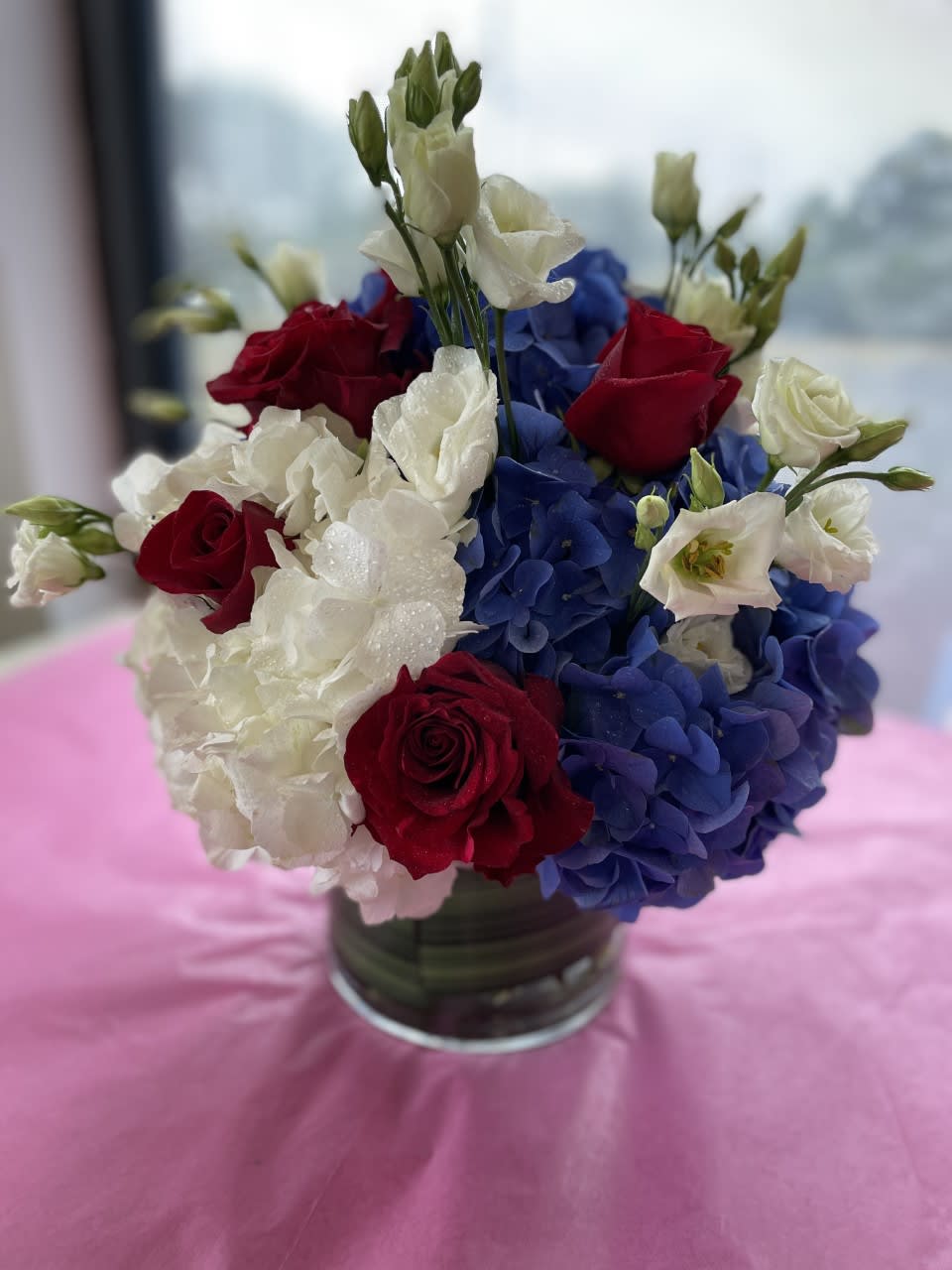 Go Traditional - Red White and Blue - In traditional Red  - White and Blue colors Made with the Finest DUTCH Blue and white Hydrangea with red Roses ( and some Lisianthus to compliment )  Standing about 14 inches tall and 12 inches wide *Available from July 2nd !!! onward.........