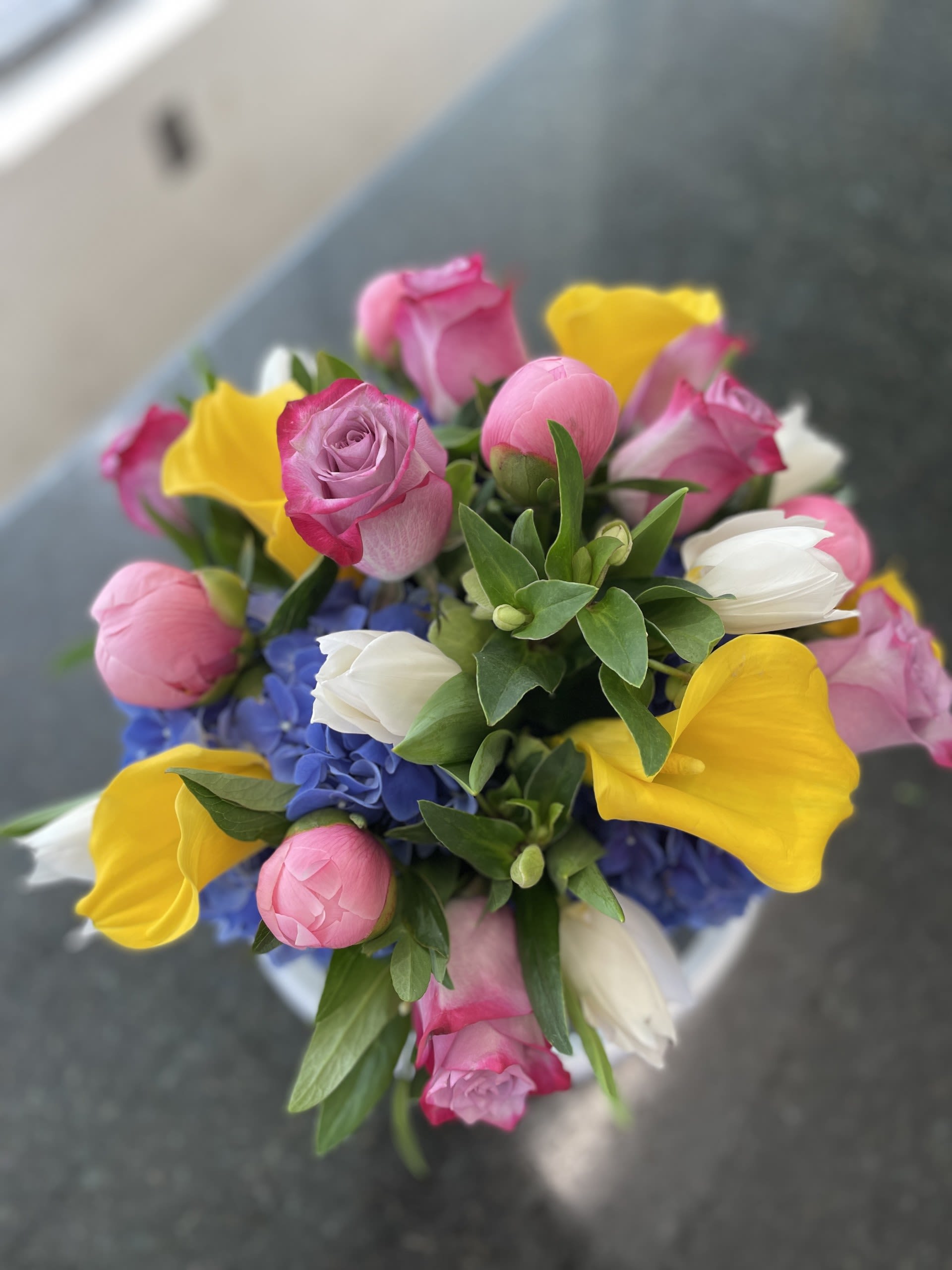 Sara's Summer Pick 2025 - Colors of the Summer - Ocean Blue / Yellow Sunshine with Roses and Peonies Arranged in a Glass Cylinder - Overall about 14 inches Tall X 12 inches Wide