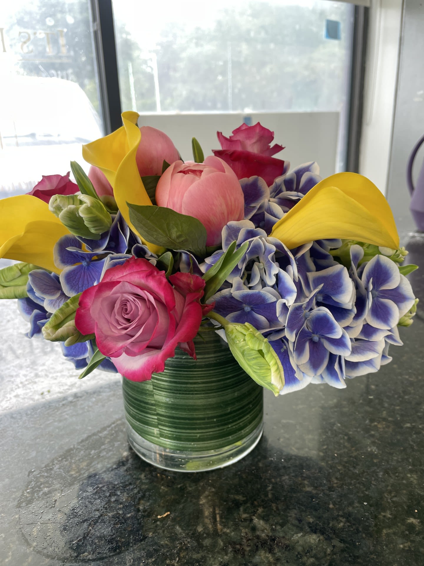Sarah's Hamptons Bouquet in a Vase -  Elegant arrangement, made with Dutch Bi-Colored Blue &amp; White Hydrangea , Peonies, Roses, and Yellow Mini Calla Lilies to give it that Summer Pop.  Measures 7 inches Tall X 7 Inches Wide