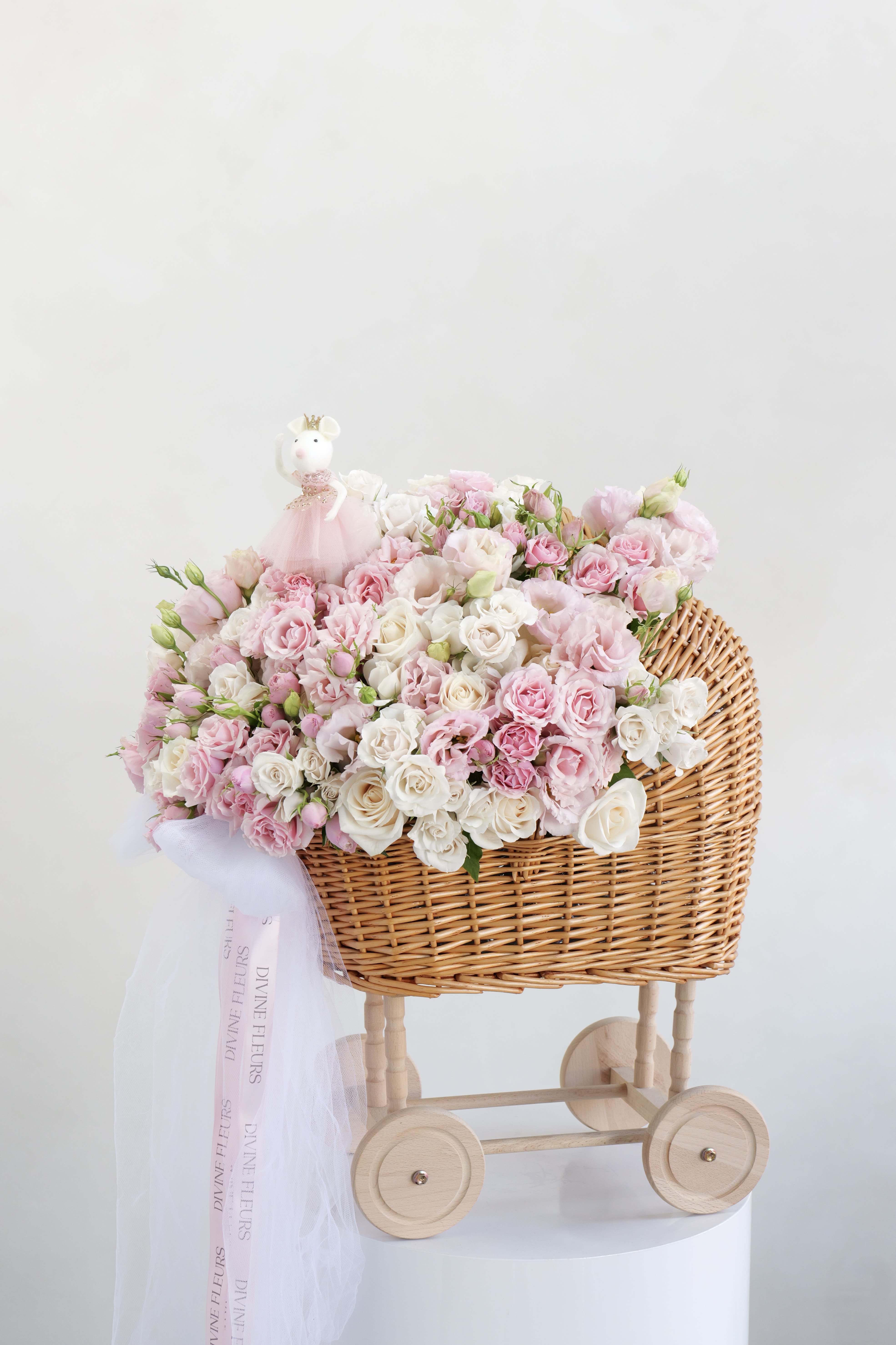 Blush Baby - A sweet blend of soft pink and white blooms, styled in a charming baby carriage — perfect for celebrating a little one.