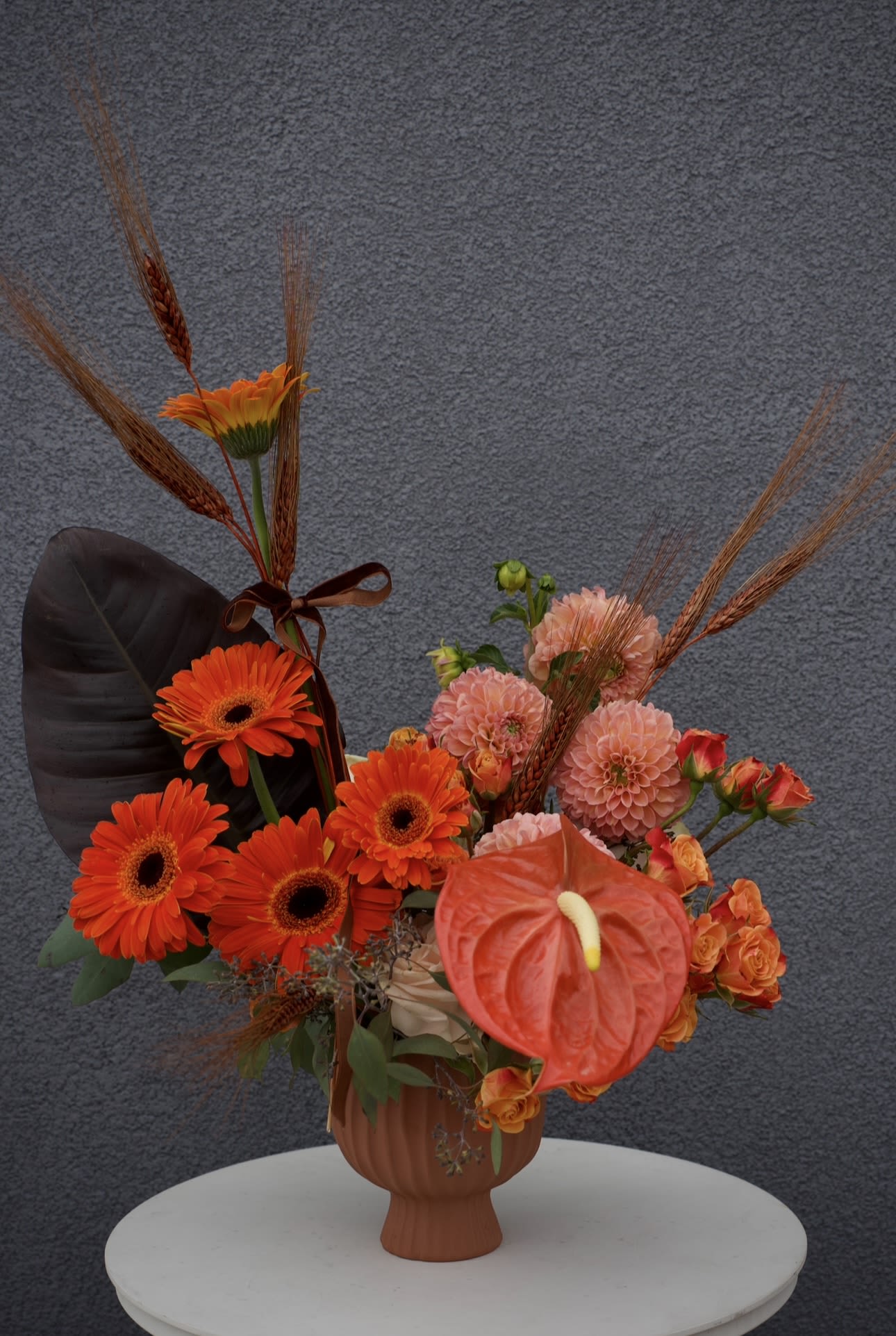 Burnt Orange - A modern floral design in rich orange and bronze tones, infused with dramatic textures and seasonal warmth.