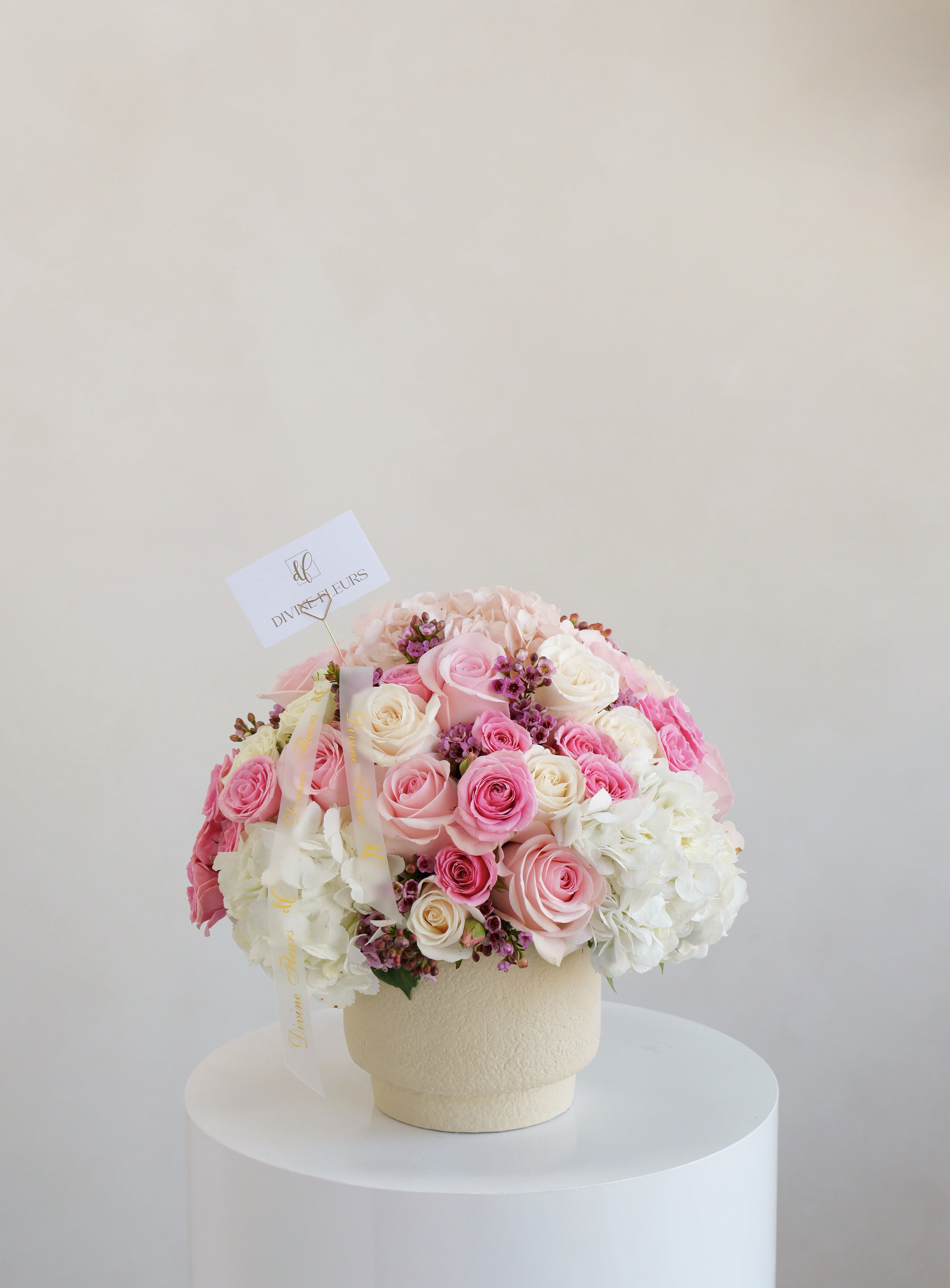 Ava Ava - A beautiful mix of pink and white roses paired with white hydrangeas, arranged in a soft-textured vase. Perfect for celebrating love, birthdays, or special moments.