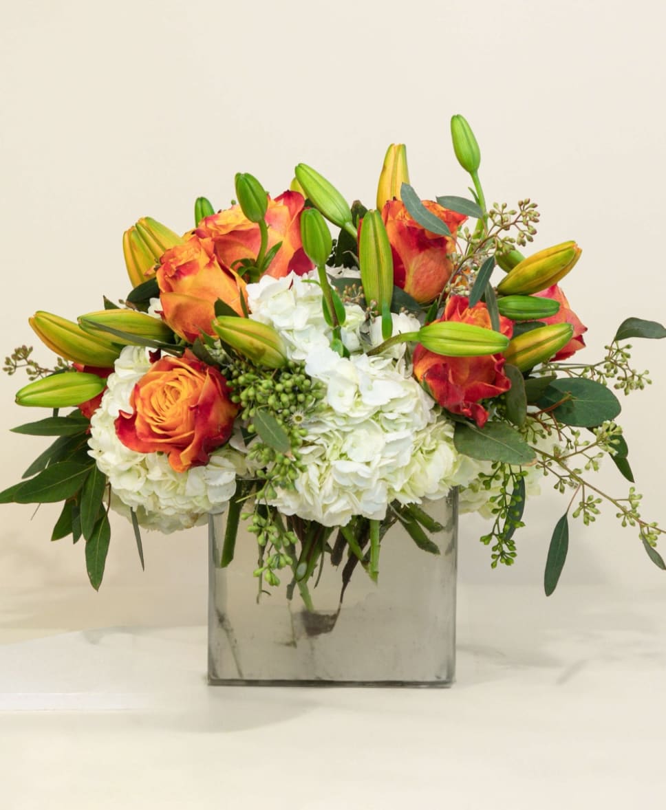 Rose and Lily Splendor Rose and Lily Splendor - Bring home all the magic and majesty one experiences with the combination of the Rose and the Lily. The splendor truly must be beheld to be believed. Includes gorgeous puffs of hydrangea.