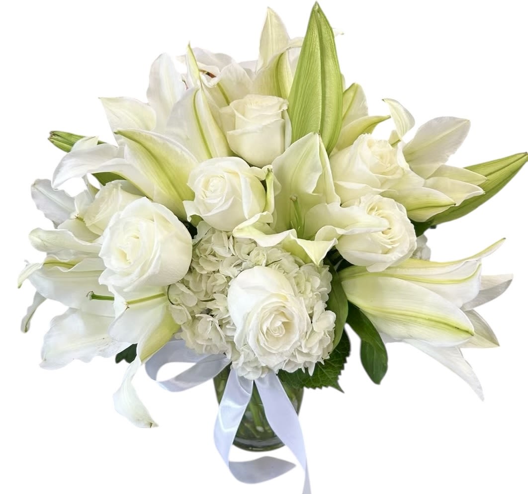 Angel’s Whisper Angel’s Whisper - A serene arrangement of pure white roses, lilies, and hydrangeas, this bouquet captures the gentle beauty of an angel’s whisper. Symbolizing purity, peace, and eternal love, it brings comfort and grace to every occasion. Perfect for weddings, sympathy tributes, or heartfelt blessings, this elegant design conveys emotions that words cannot express.