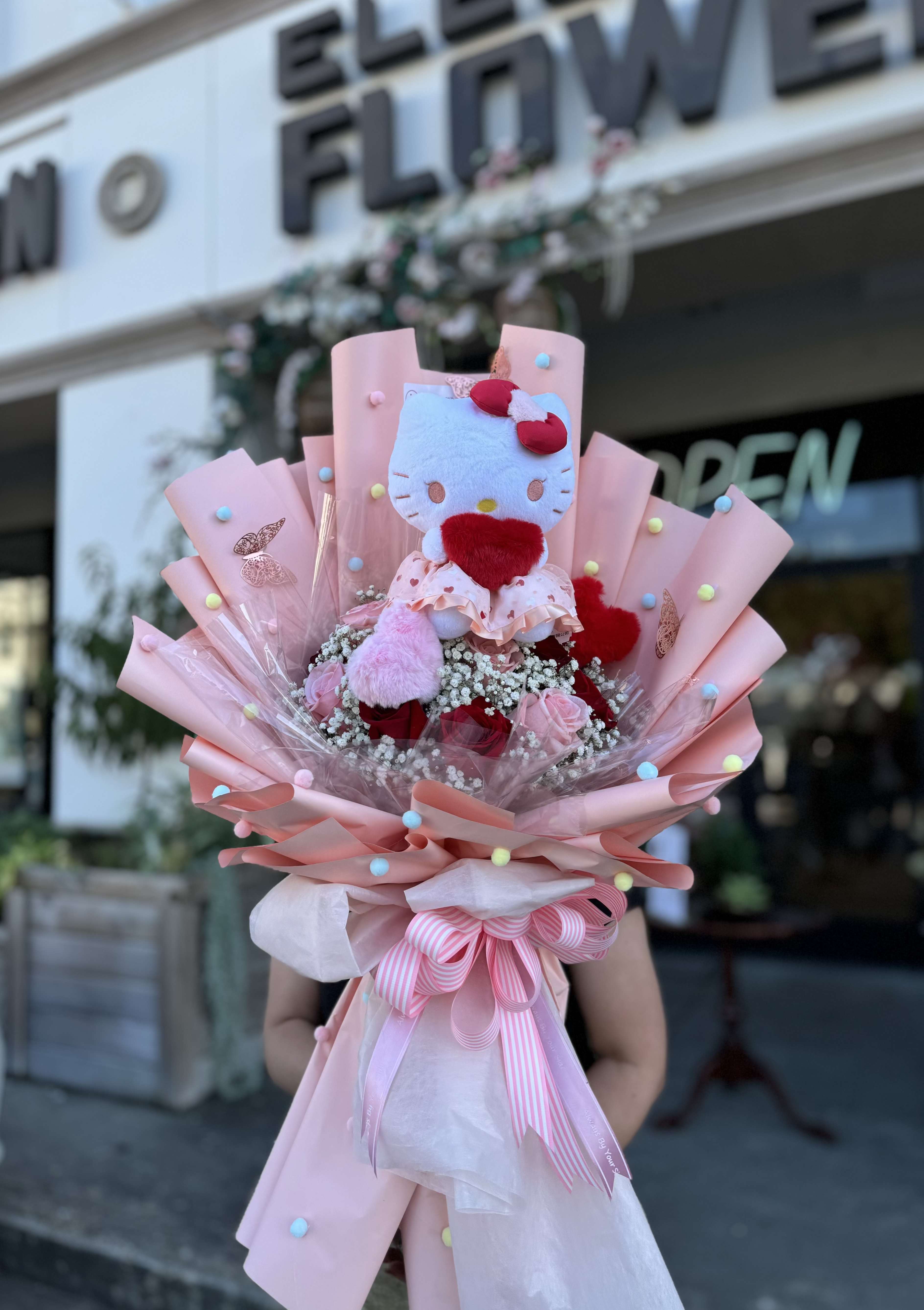 Sanrio Collection / Hello Kitty #1 Sanrio Collection / Hello Kitty #1 - A wrapped bouquet of flowers is a beautifully arranged collection of blooms, carefully selected and elegantly wrapped in decorative paper or fabric. These bouquets often feature a mix of fresh, vibrant flowers, and complemented by lush greenery. Wrapped bouquets are perfect for any occasion, from expressing love and gratitude to celebrating special moments, offering a thoughtful and visually stunning gift.
