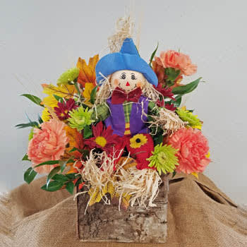 Be Happy - Doesn't our happy scarecrow just make you smile?  That is what we had in mind.  Colorful and bright fall arrangement in a birch box container.