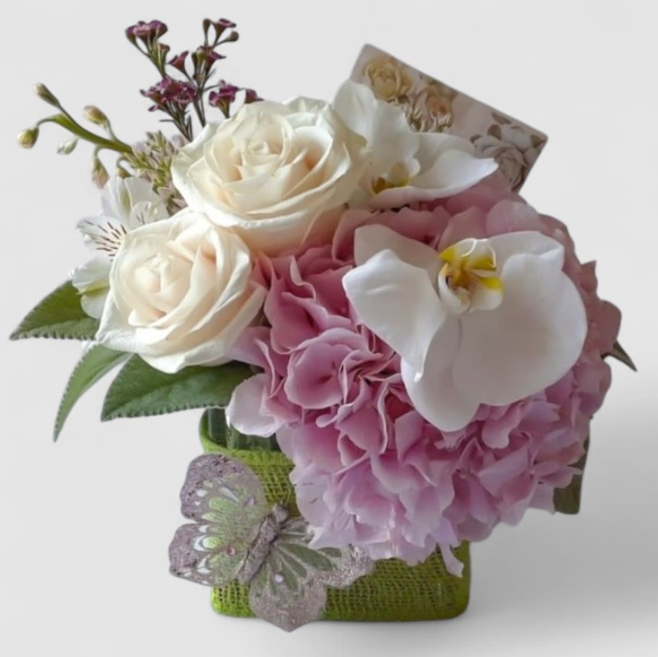 Pink Bouquet - Send this pretty bouquet today to make them smile with it's lovely pink blossoms roses orchids arranged in a modern glass cube vase wrapped in beautiful citrus jute ribbon adorned with a cheerful springtime butterfly. Perfect to send today to send them happiness. Please visit my beautiful gallery to see my most recent designs that I have created of my online customers. Send them smiles today.