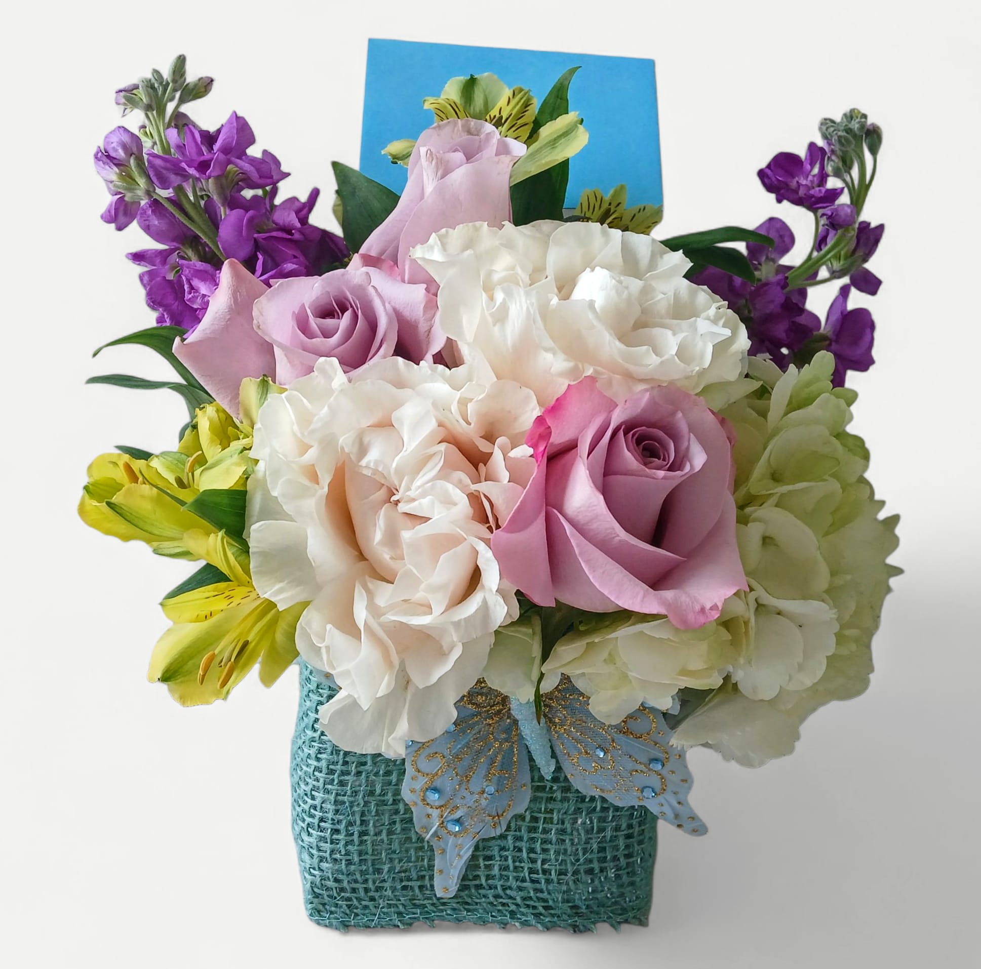 Sweet Lavender Mint Beauty Bouquet - Send this beautiful sweet size lavender mint blossoms cutie today to make them smile with roses hydrangea stock and more arranged in a modern glass cube style vase wrapped in pretty turquoise ribbon adorned with a sweet cheerful blue butterfly. This bouquet is perfect to send for a birthday, get well, thinking of you or any occasion when you want to cheer them up. All of my bouquets are always made extra special each time. Please kindly feel free to tip our talented hard working designers and our hard working drivers so that we can continue to provide you with our excellence. Have a blessed day. Haddon Township, Haddonfield and surrounding local South Jersey towns flower delivery. 