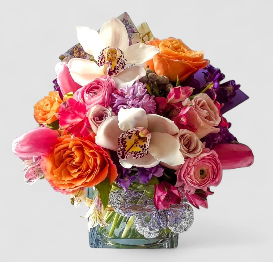 Happy Anniversary Mixed Blossoms Beauty Designer's Choice - Perfect for every occasion. Send them this beauty today to show them how much you care with it's beautiful mixed blossoms of that day roses orchids and more in a modern glass cube vase. Perfect for every occasion. All flower arrangements that leave my studio are beautiful one of a kind works of art. Please visit my beautiful gallery to see my latest designs that I have created for my online customers. Send them happiness. Send them a special bouquet to make them smile today.