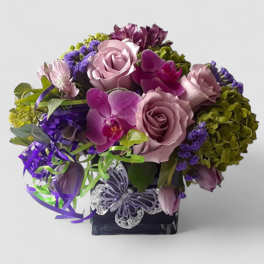 Purples In Black Designer's Choice - Designer's choice; made beautifully from my purple blossom selection of the day roses orchids and more arranged in a black modern glass cube style vase. Perfect to send for every occasion t show them how much you care. All bouquets are always made extra special and unique each time. Send them happiness.