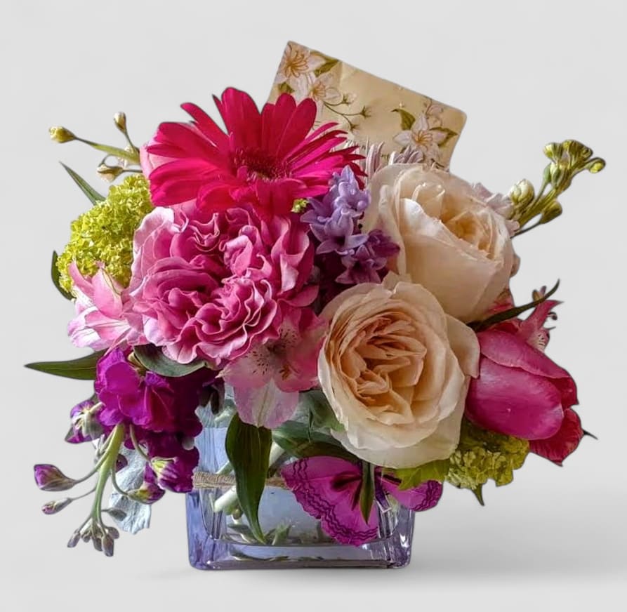 Pink And Purple Roses And Orchids Beautiful Bouquet - Perfect for every occasion. Send this beautiful bouquet today to show them how much you care with it's beautiful mixed pink and purple cheerful blossoms of that day roses orchids and more arranged in a modern glass cube vase. All fresh flower bouquets that leave my flower studio are works of art, made with lot of care. Please visit my beautiful gallery to see my most recent designs that I have created for my online customers. Send them happiness. Send them a special bouquet to make them smile today.
