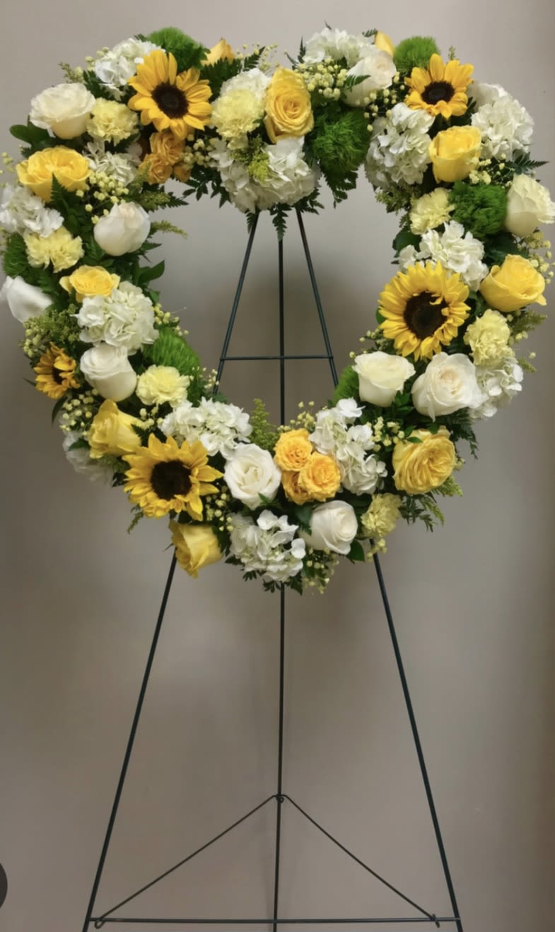 Heart and Soul - This heart easel is in shades of yellow and white. It features sunflowers, roses, hydrangeas and other flowers bringing in the sunshine.